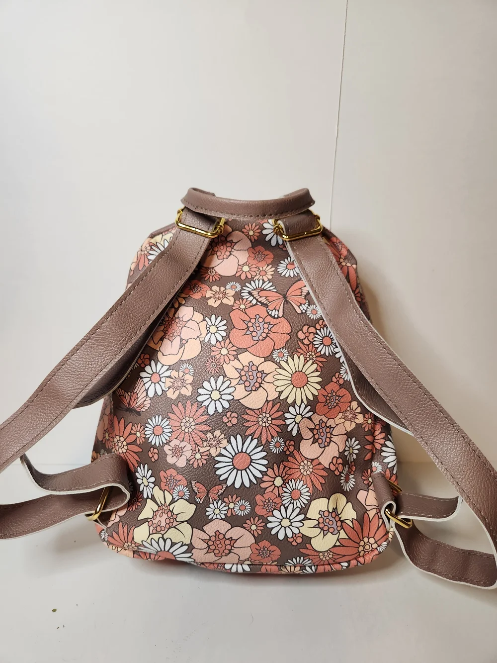 Jessica Simpson backpack with butterfly design.